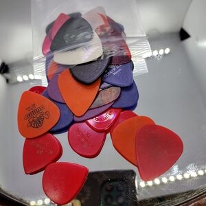 Assorted Guitar Picks in Red, Orange, and Purple